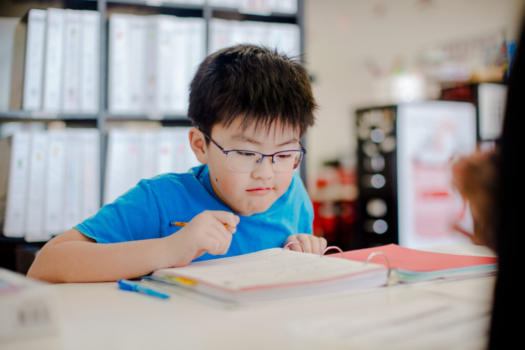 Jonathan Kim looks at a problem in his notebook full of math exercises. 