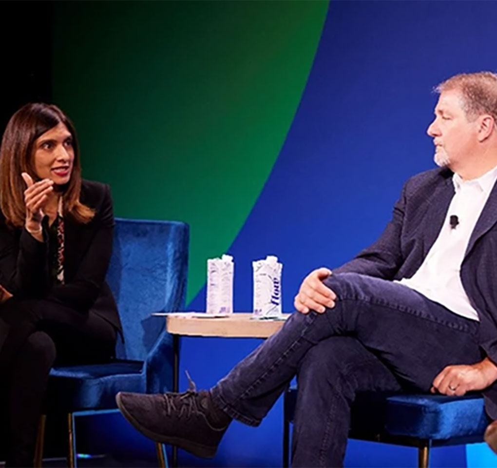 Woman and man having a discussion on the stage of a technology event
