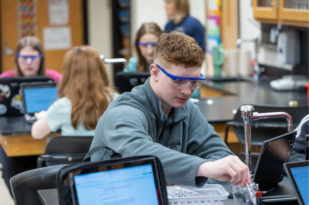 Picture of high school student, Aleksandar Tatum working on a chemistry experiment.