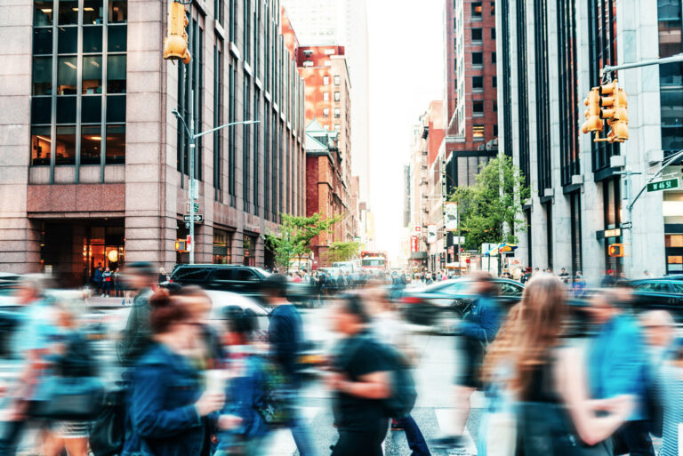 A view of a city with a blurred view of people walking