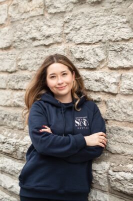 Portrait of Haut.AI co-founder and CEO Anastasia Georgievskaya leaning against a brick wall.