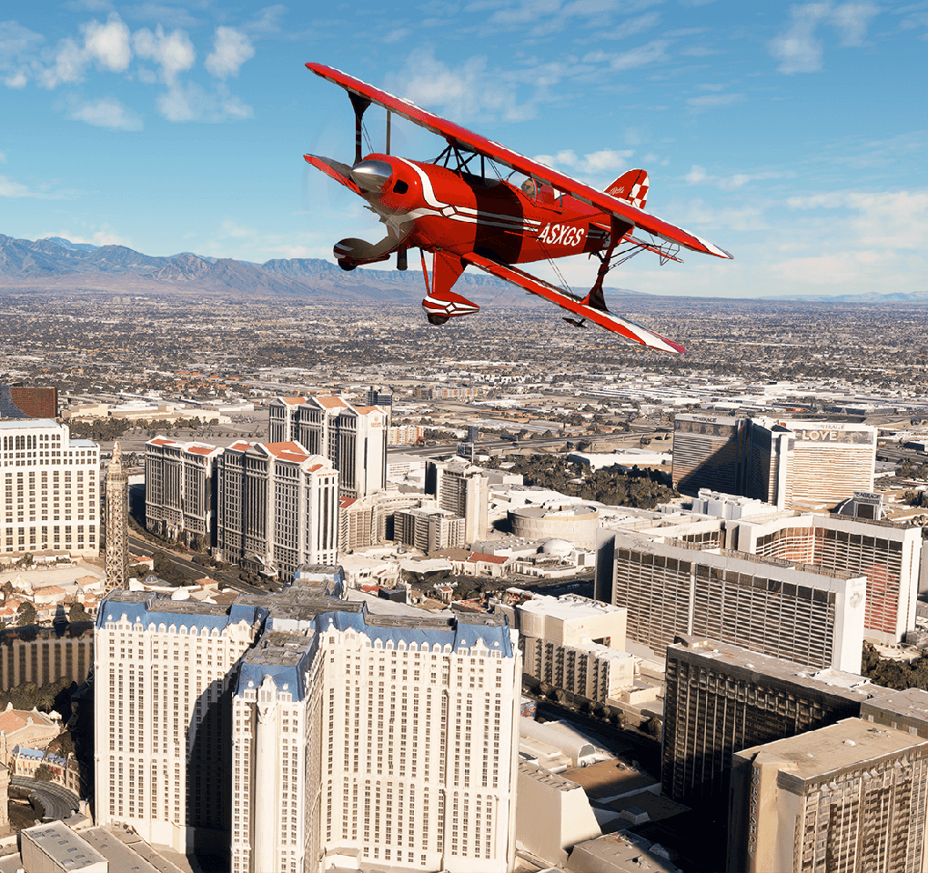 Red biplane flying over Las Vegas