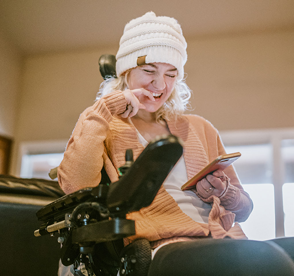 Woman in a wheelchair enjoying what's on her phone