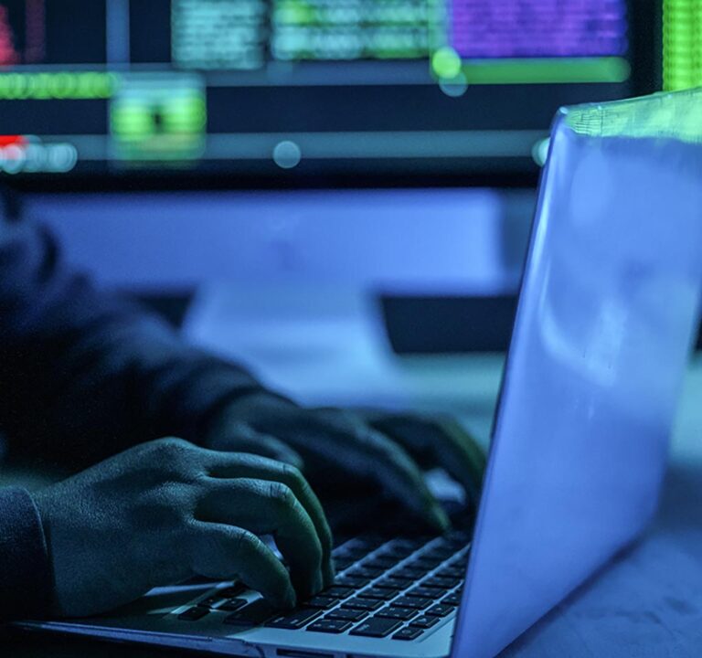 Fingers typing at a laptop computer