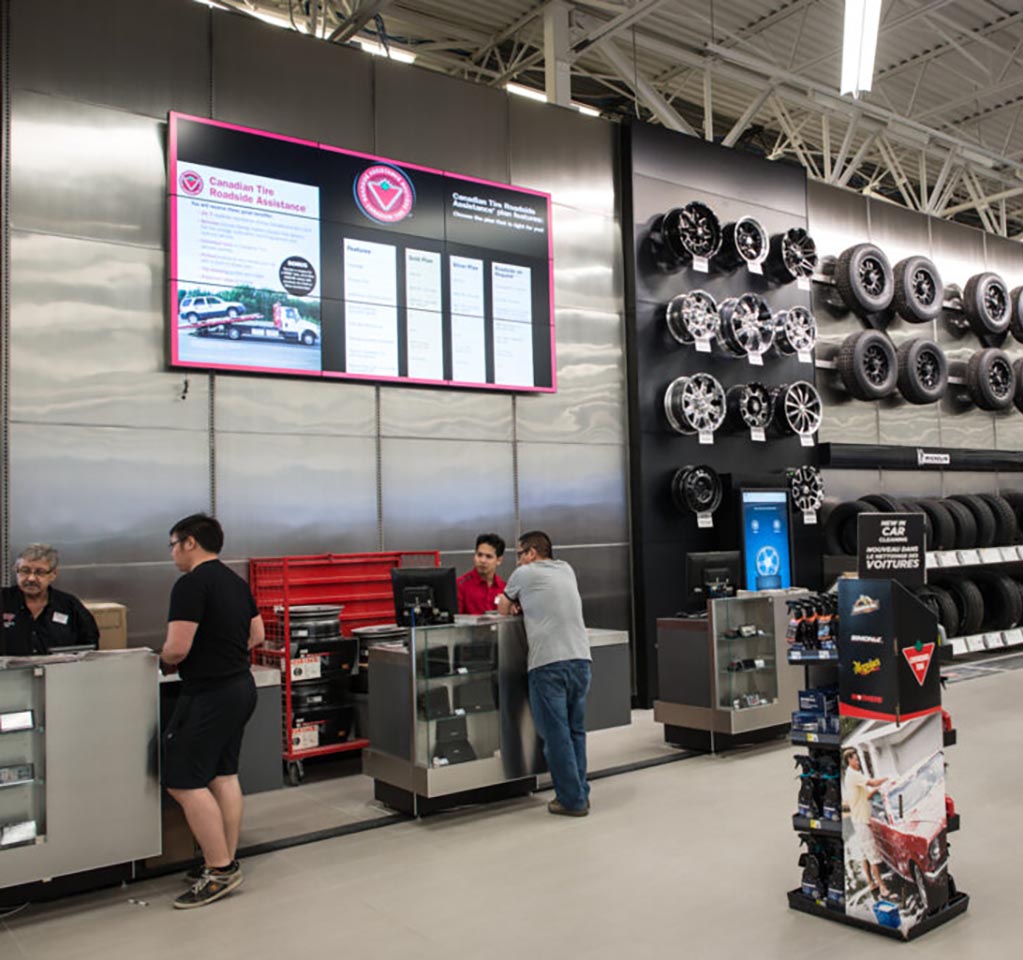 Customers interacting with salespeople at a tire store