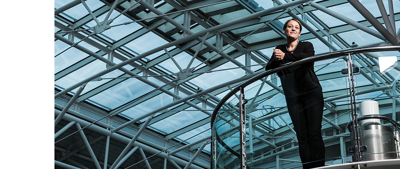 Jenny Cook, head of strategy and research for Guide Dogs. Photographic portrait taken on a glass staircase at Paddington Station