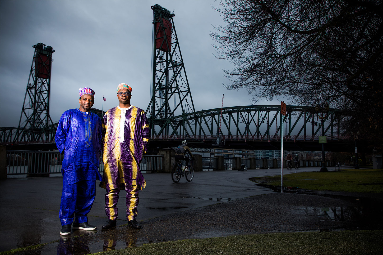 Photograph of brothers Ibrahima and Abdoulaye Barry in front of a bridge on the Willamette River in Portland, Oregon