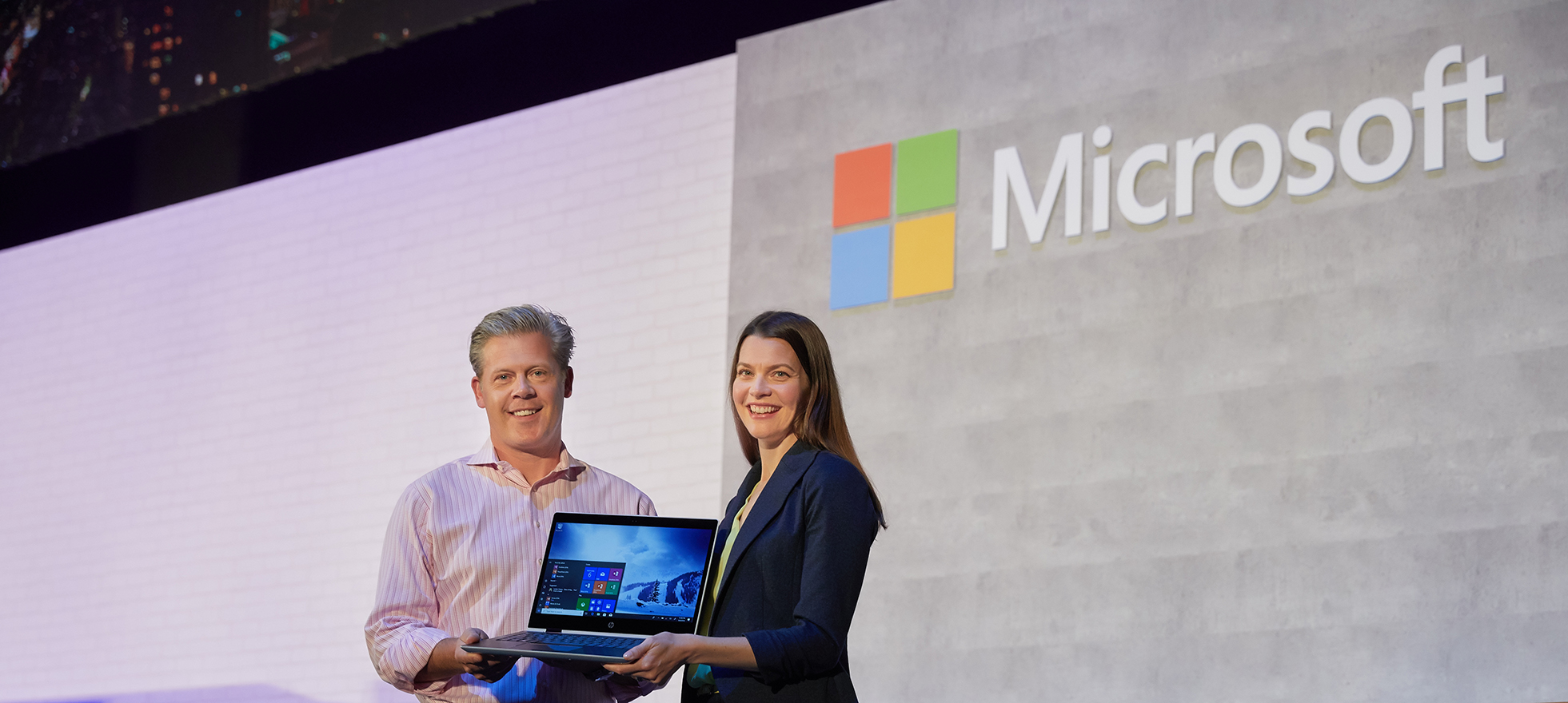 Nick Parker and Roanne Sones hold the new HP ProBook x360 on stage
