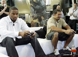 New York Giants football players Osi Umenyiora (left) and Kawika Mitchell challenge each other in an on-screen battle during a "Halo 3" preview party at Best Buy in Manhattan, Monday, Sept. 24, 2007.