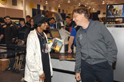 Microsoft Chairman Bill Gates (right) presents a copy of Halo 3 to the first fan in line, Ritesh David, at midnight, Sept. 25 in Bellevue, Wash. 