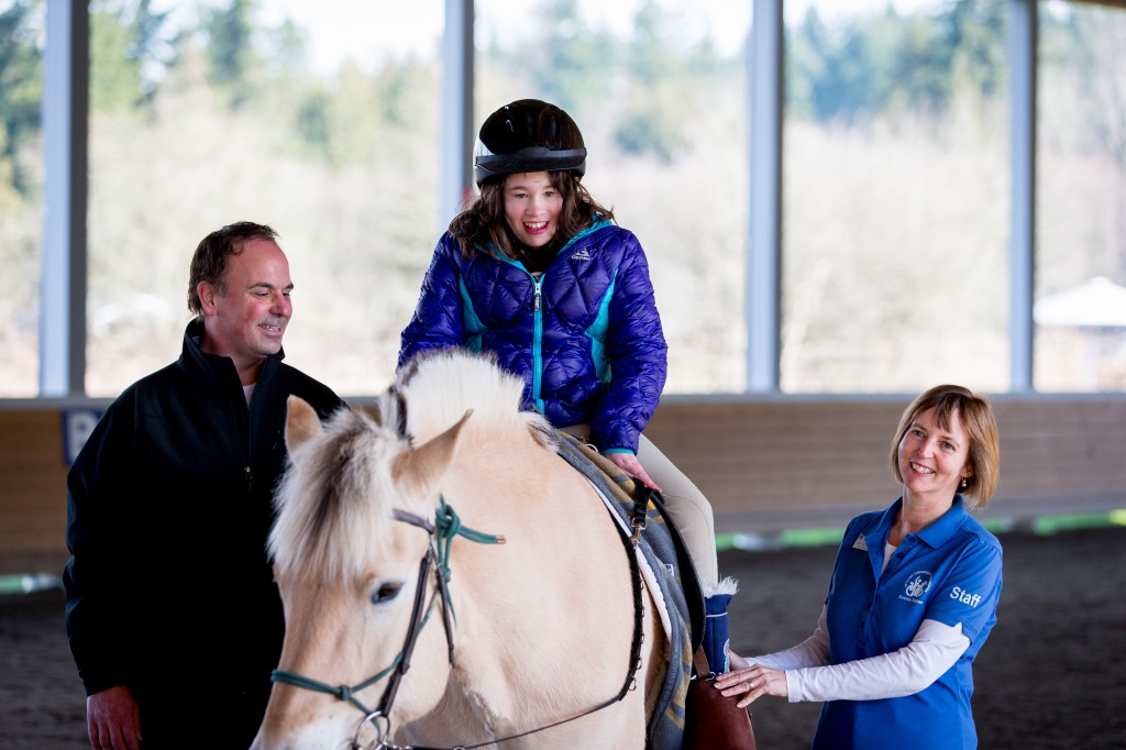 Jeff Gollnick, left, and Cluny McCaffrey, right, with client Sadie at Little Bit Therapeutic Riding Center.