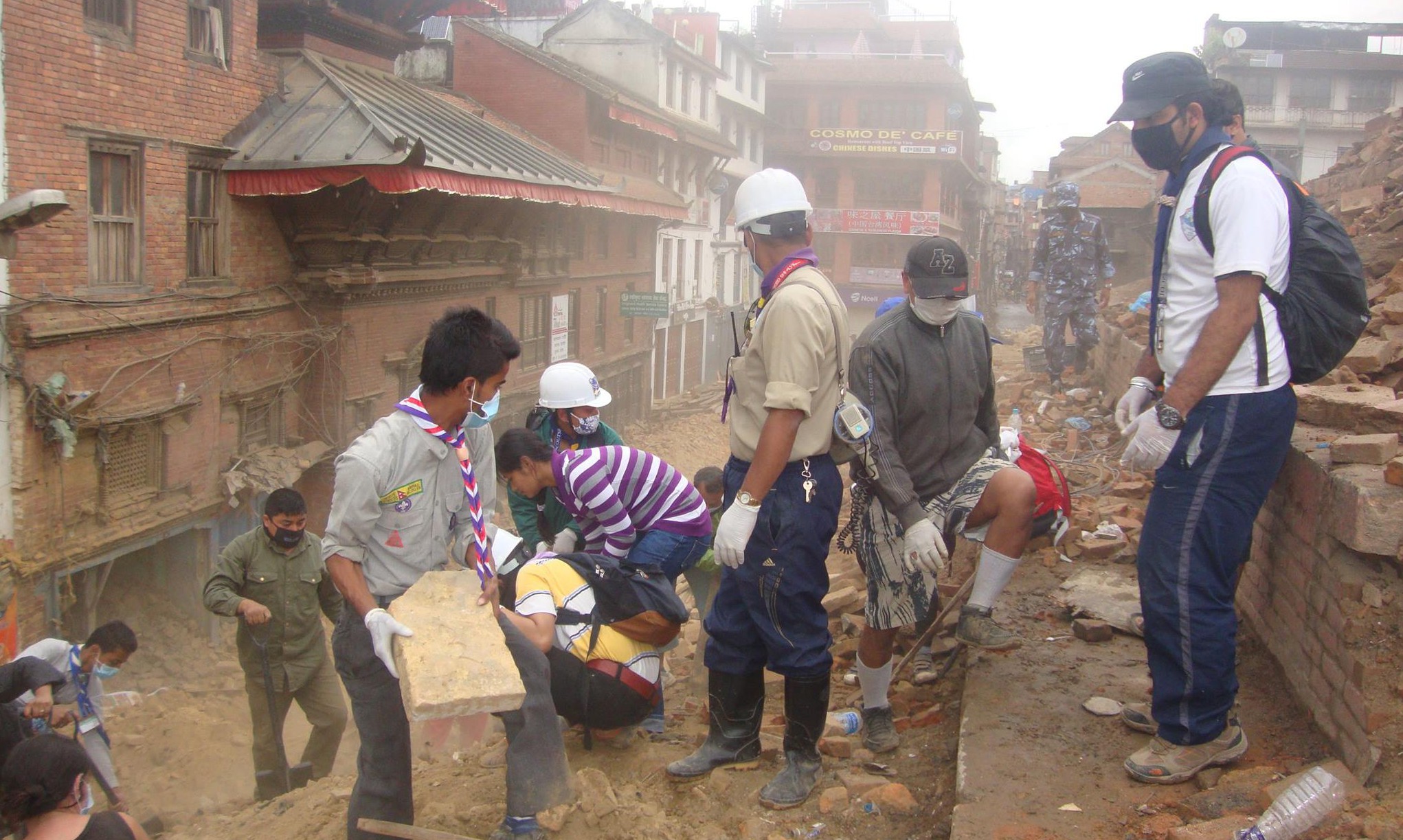 Scouts help relief workers to clear rubble following deadly earthquakes in the Kathmandu Valley