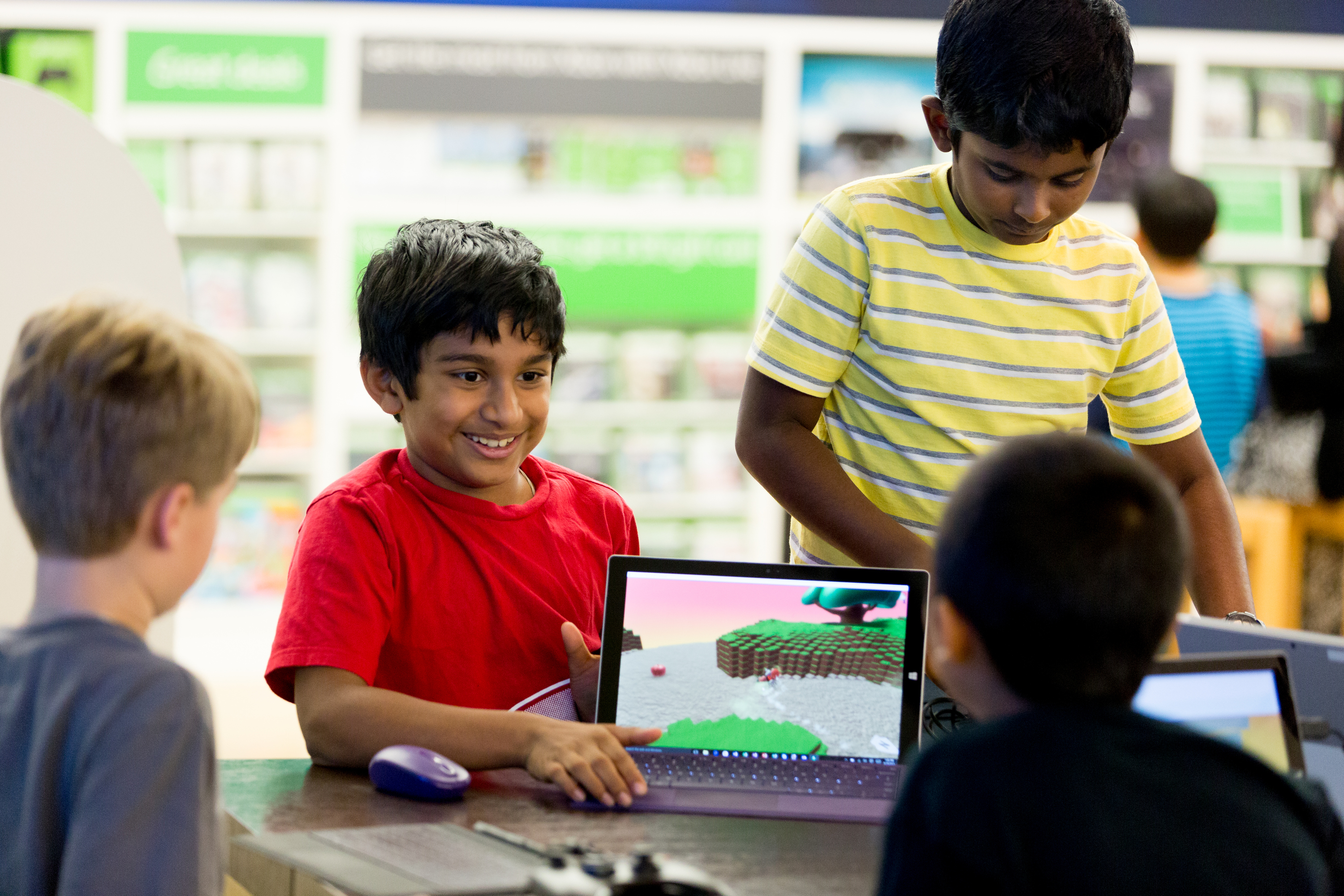 At the YouthSpark Summer Camp at Microsoft at Bellevue Square Mall, Anikait Vishwanathan, 9, is happy with the results of his work; at right, Soathvik Somujayabalan, 9, concentrates on what he’s working on. Photo credit: Scott Eklund, Red Box Pictures.
