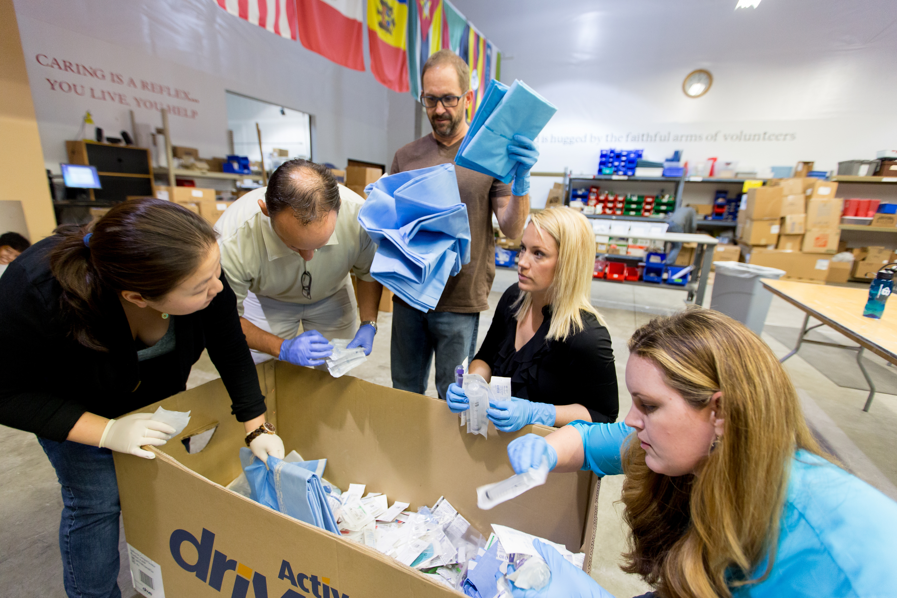 The team begins sorting medical supplies at Medical Teams International. (Photo by Scott Eklund/Red Box Pictures)