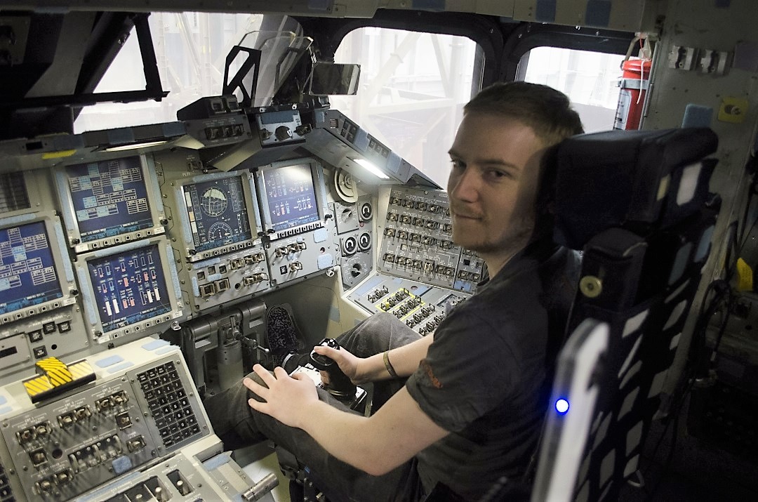 Liam McGuire gets a feel for being in the shuttle cockpit.