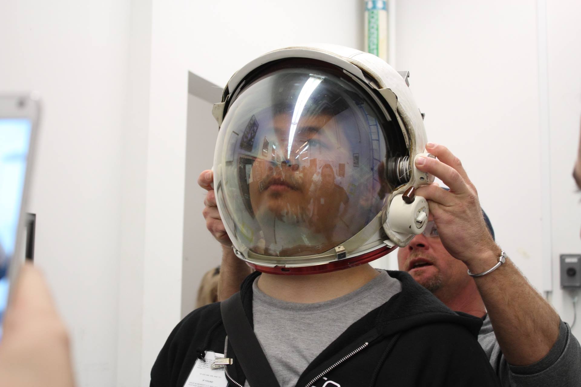 Trying on a spacesuit helmet at NASA’s Johnson Space Center helps Norman Wang assess an astronaut’s field of vision.