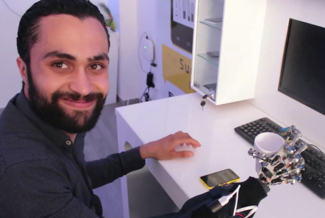 Mohamed Zied Cherif uses Smart Hand to pick up a coffee cup.