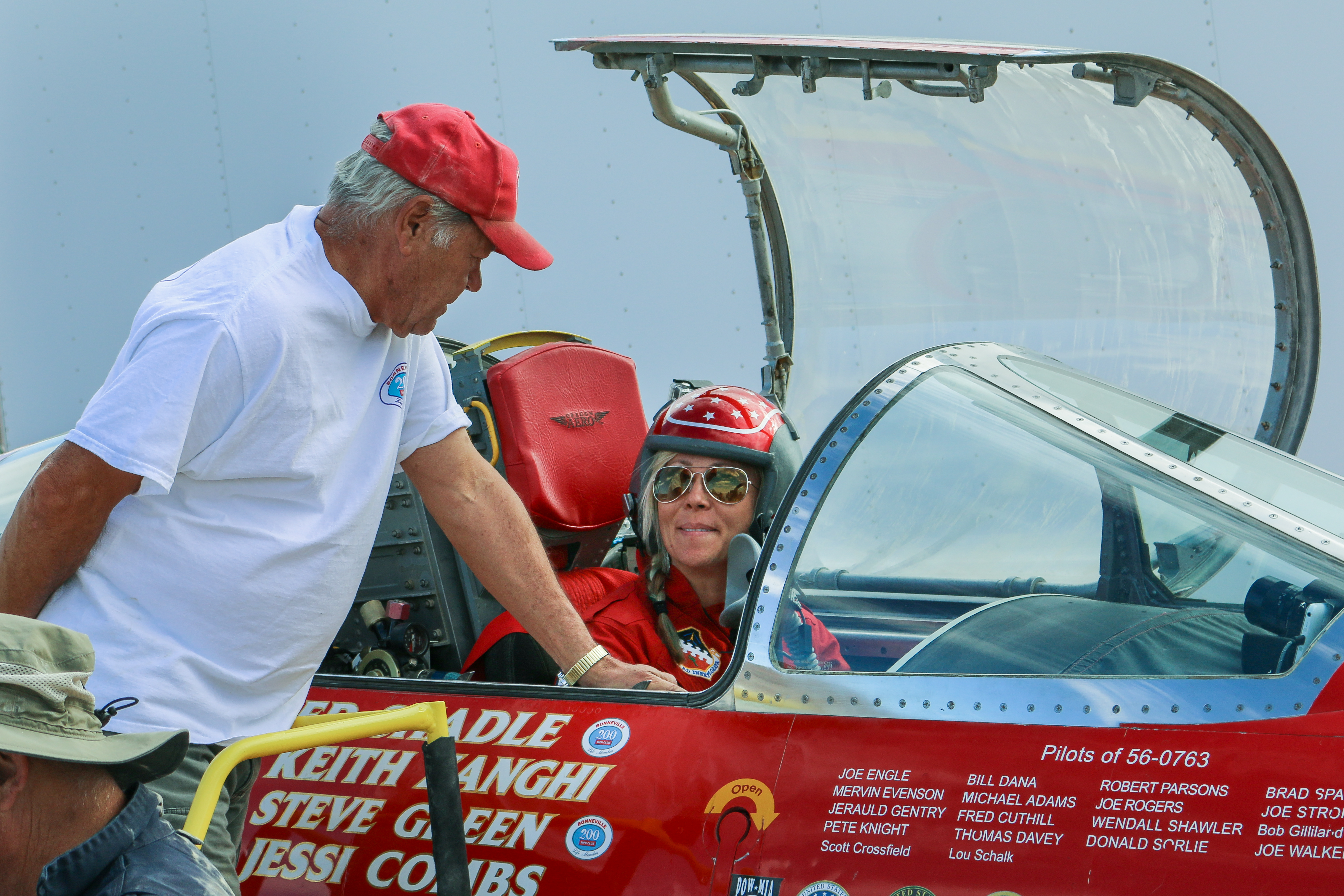 Jessi Combs sits in cockpit of North American Eagle while Ed Shadle stands next to it