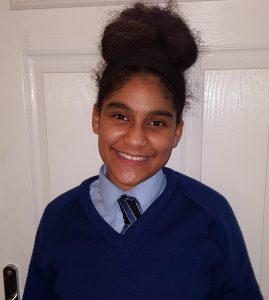 Photo of smiling girl in school uniform