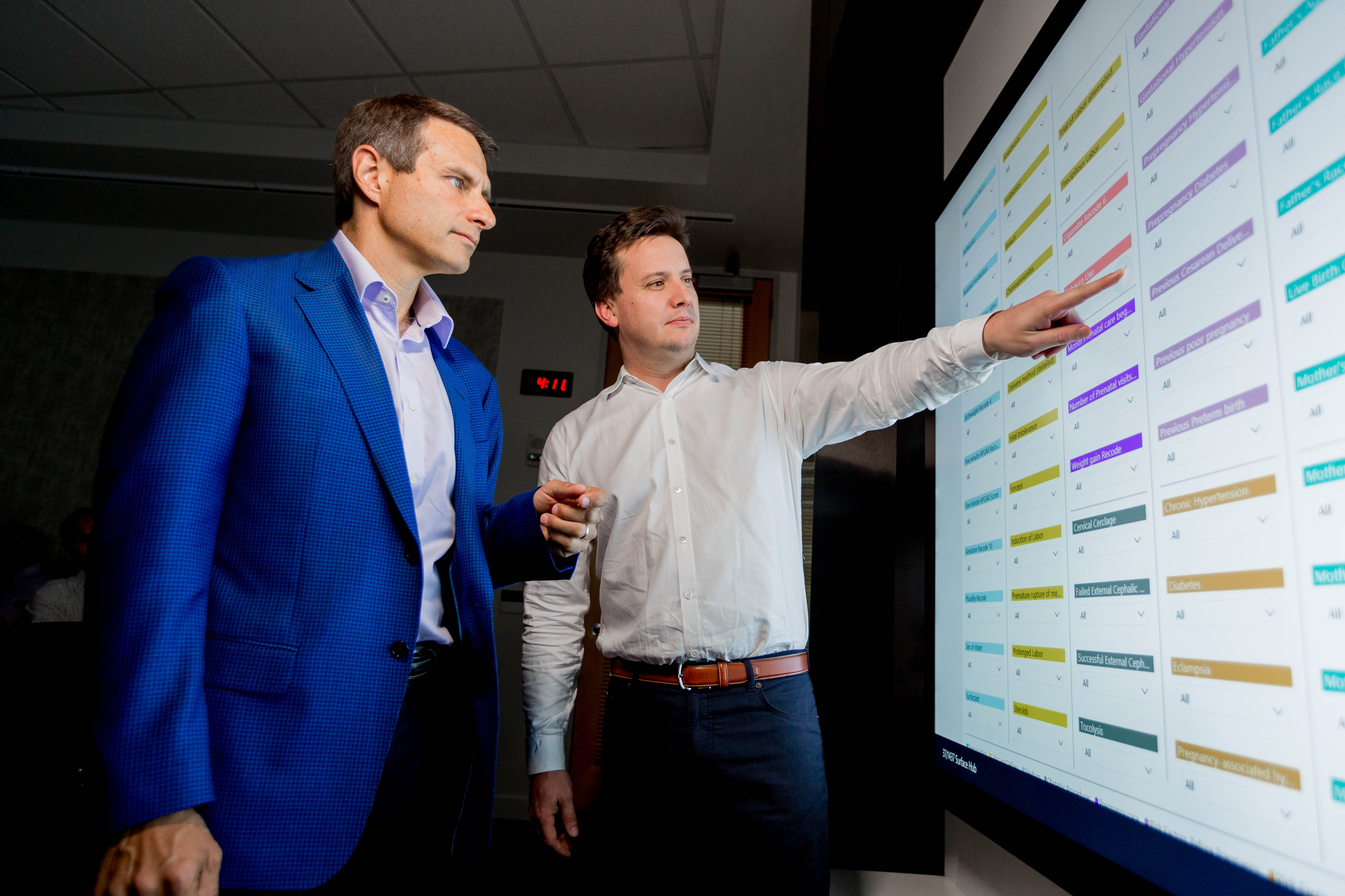 John Kahan, left, and Juan Lavista Flores, look over some of the SIDS-related correlations generated by the research tool developed by Microsoft volunteers