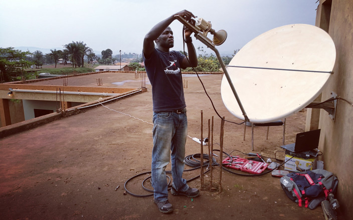 Alex Okuonzi Bahati works on installing Wi-Fi