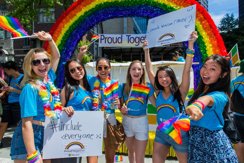 Photo of group of young women in front of Microsoft's float in the 2017 Seattle Pride parade