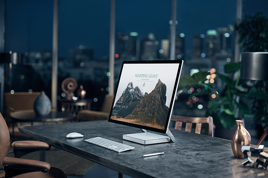 Surface Studio on a desk, it's night-time outside