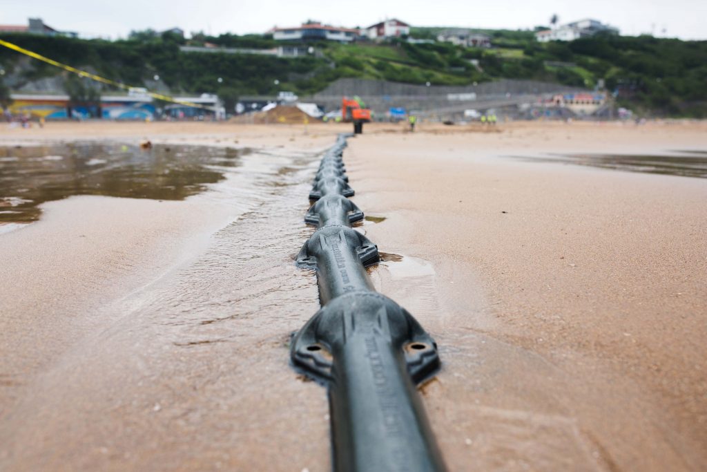 Marea cable laying across sandy shore in Spain