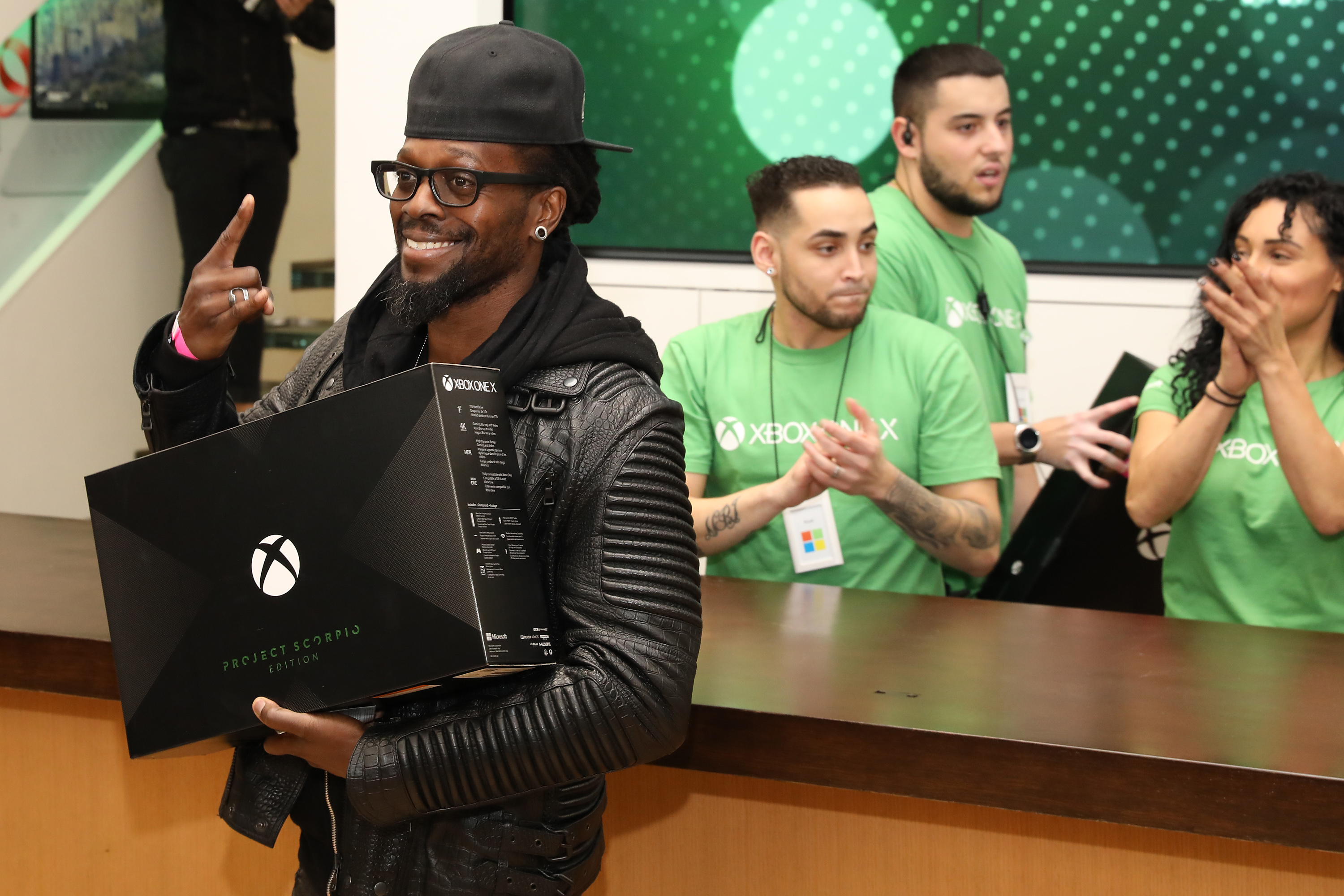 A fan celebrates purchasing an Xbox One X Project Scorpio Edition at the flagship Microsoft Store on Fifth Avenue on Tuesday, Nov. 7th, 2017, in New York City. (Photo by Amy Sussman/Invision for Microsoft/AP Images)