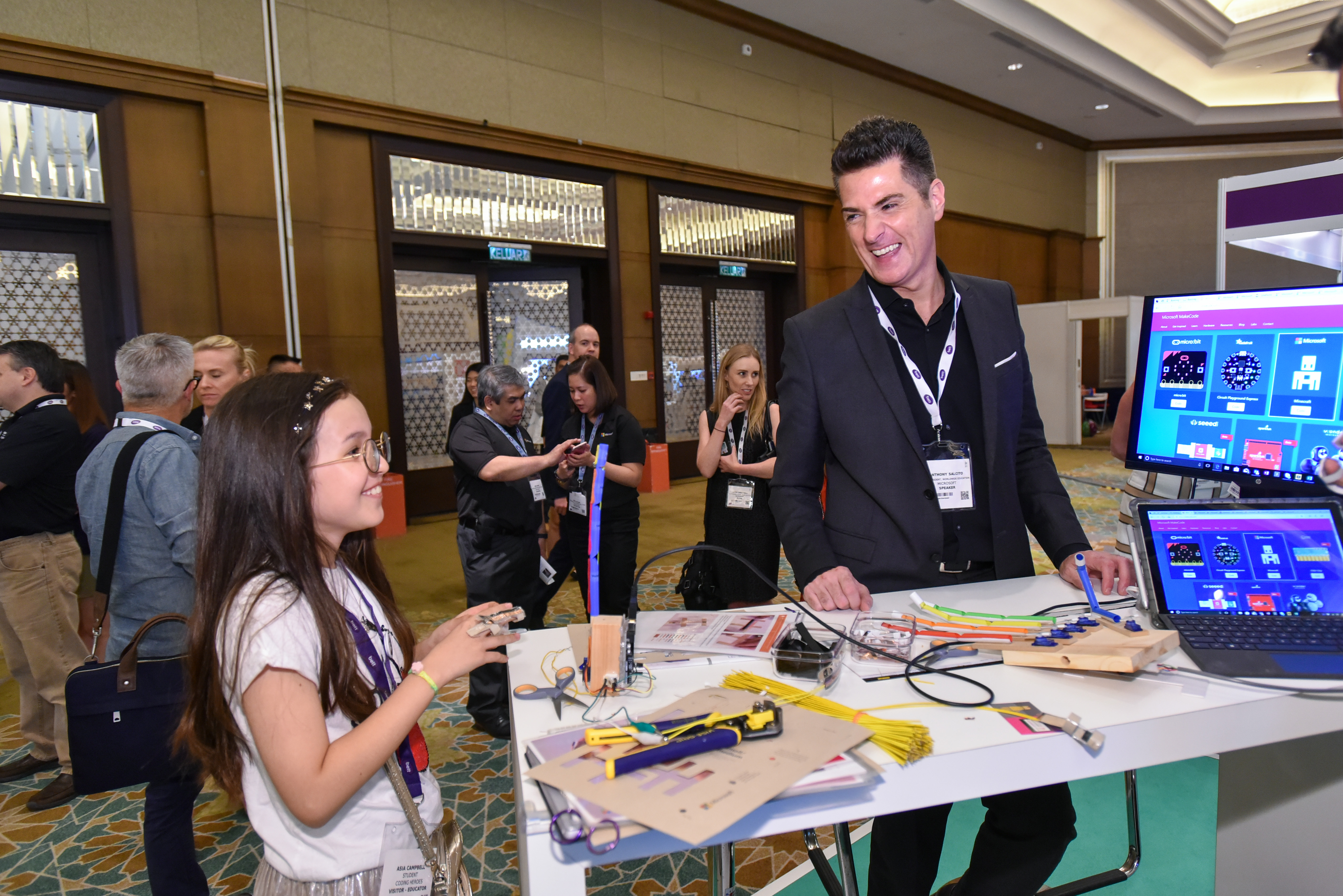 Anthony Salcito, Vice President of Worldwide Education, Microsoft sharing a candid moment with a student trying her hands at basic coding at Bett Asia