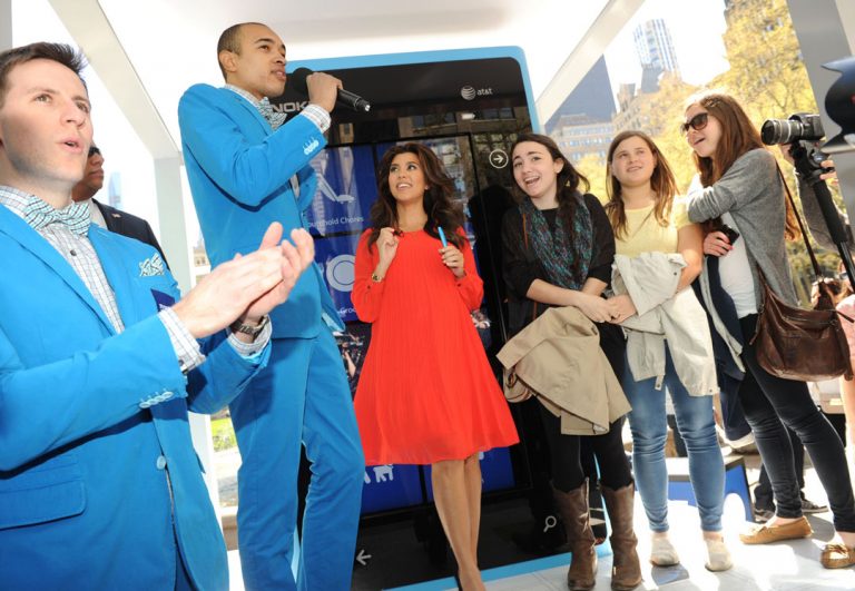 Jessica Cohen, 18, center right, of New York, learns that she's won a day of shopping and pampering with Kourtney Kardashian, center left, at the Windows Phone Free-Time Machine, Monday, April 9, 2012, at Bryant Park in New York.
