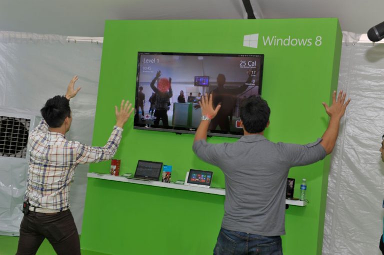 Attendees try out new devices at Microsoft Corp.’s regional launch of Windows 8 in Singapore on Thursday, Oct. 25.