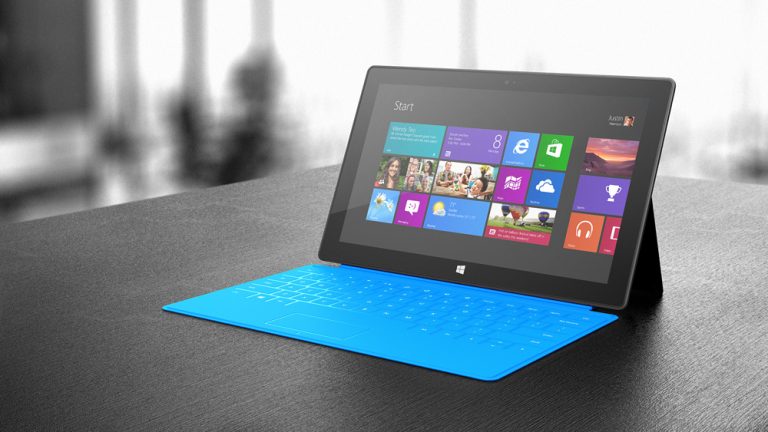 A front view of Surface, shown with a cyan Touch Cover, one of five colors available.