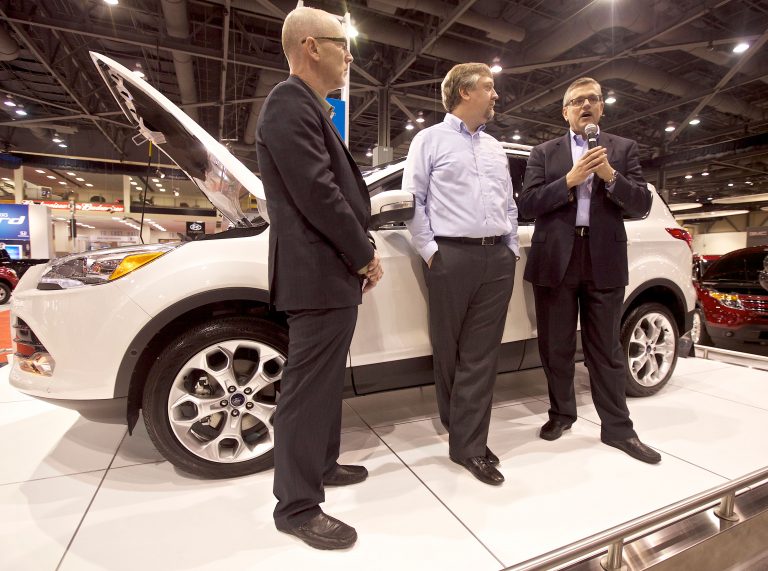 Ford's Director of Electrical and Electronics Systems Jim Buczkowski, right, speaks about the Ford Microsoftpartnership during a media brief while Technology writer Doug Newcomb left, and Microsoft Senior Program Manager for Windows Embedded Walter Sullivan listen at the Ford SYNC, powered by Microsoft, Fifth Anniversary celebration during the first day of the Seattle Auto Show on Wednesday, Nov. 14, 2012 in Seattle. Microsoft and Ford are celebrating Ford SYNC in five million vehicles. Ford SYNC is an in-vehicle connectivity system that enables voice-control for mobile phones and music players using the Windows Embedded Automotive software platform.