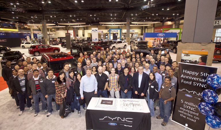 Microsoft Windows Embedded Automotive employees pose for a picture at the Ford SYNC, powered by Microsoft, Fifth Anniversary celebration during the first day of the Seattle Auto Show on Wednesday, Nov. 14, 2012 in Seattle. Microsoft and Ford are celebrating Ford SYNC in five million vehicles. Ford SYNC is an in-vehicle connectivity system that enables voice-control for mobile phones and music players using the Windows Embedded Automotive software platform.