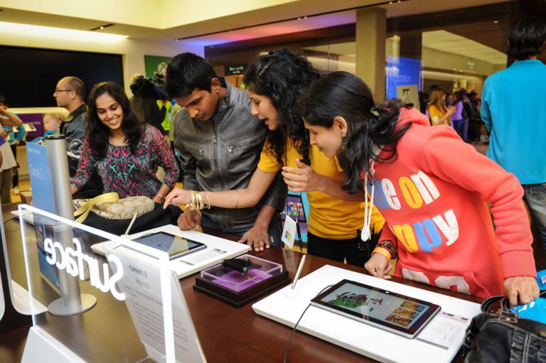 An associate shows off Surface 2 to customers at the Surface Midnight Launch at the Bellevue Square Microsoft Store in Bellevue, Wash., on Oct. 21, 2013. The event was one of 10 across the country.