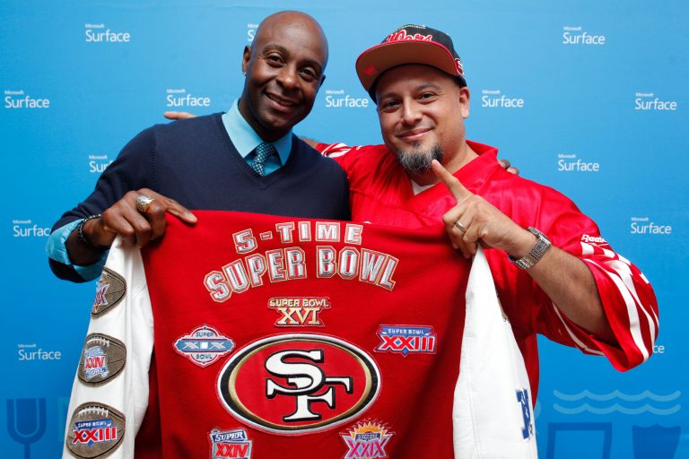 Retired NFL wide receiver Jerry Rice with a fan at the Westfield San Francisco Centre Microsoft Store.