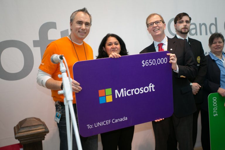 David Morley, president and CEO, UNICEF Canada, accepts a $650,000 software grant during the ribbon-cutting ceremony at the Square One Shopping Centre Microsoft retail store opening on Feb. 8, 2014.
