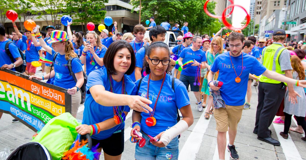 A Microsoft employee tosses wrist bands into the crowd as she marches in the 41st Annual Seattle Pride Parade on Sunday.