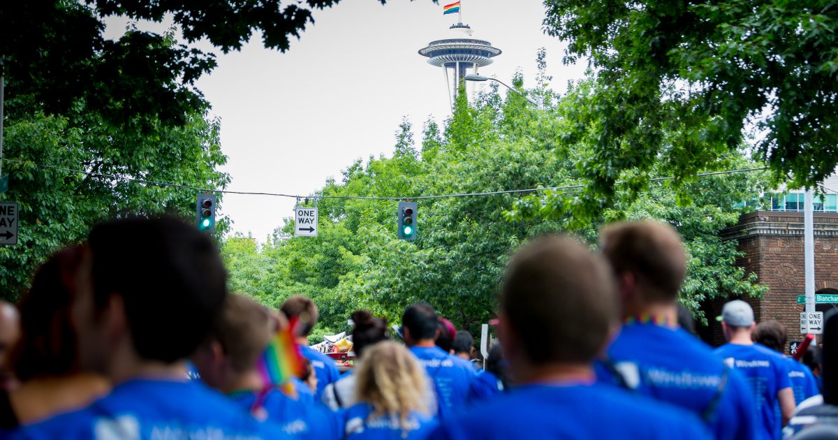 Microsoft employees, partners, family and friends march toward the Space Needle on downtown Seattle streets.