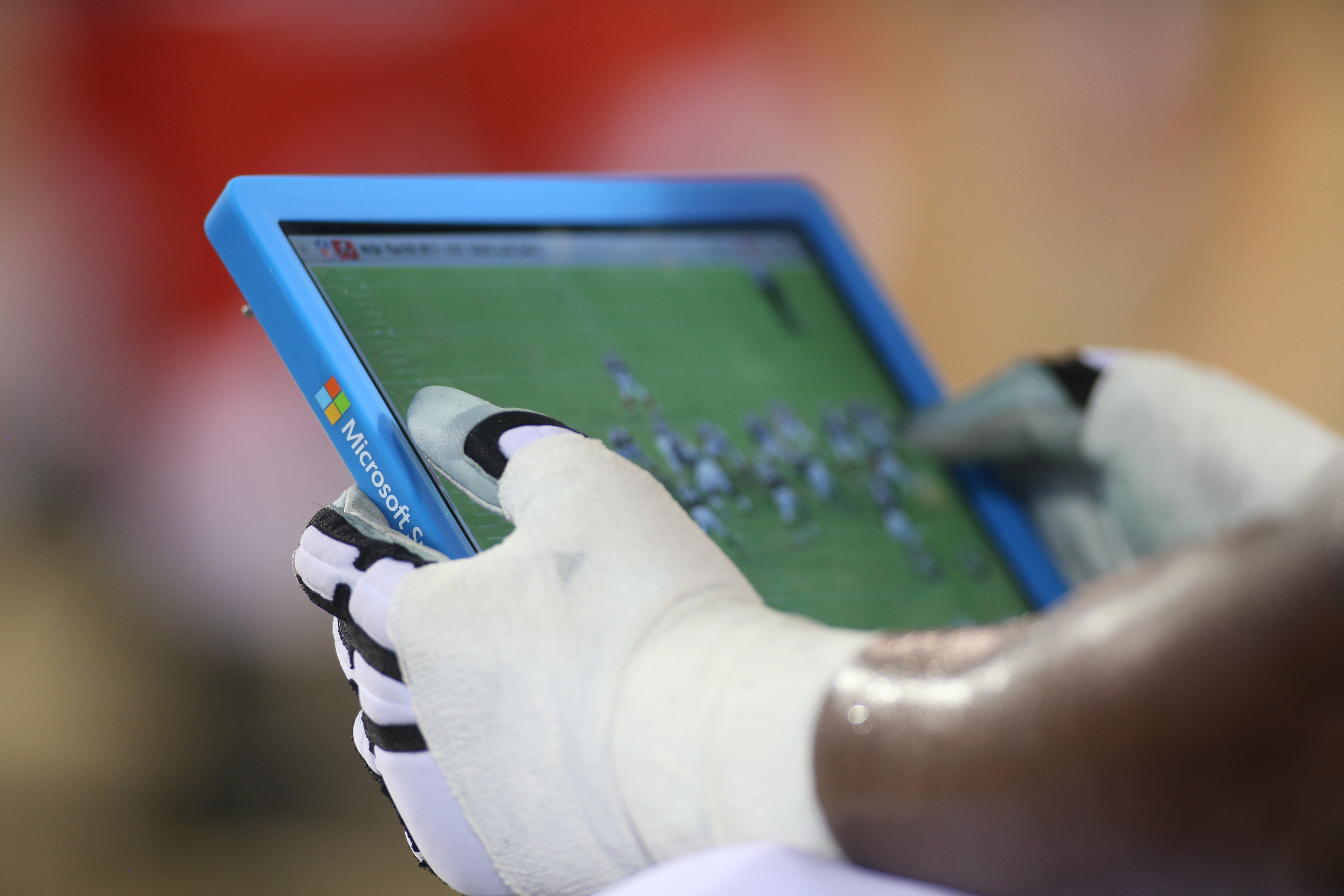 Close-up of a Surface tablet in a player's hands watching a play
