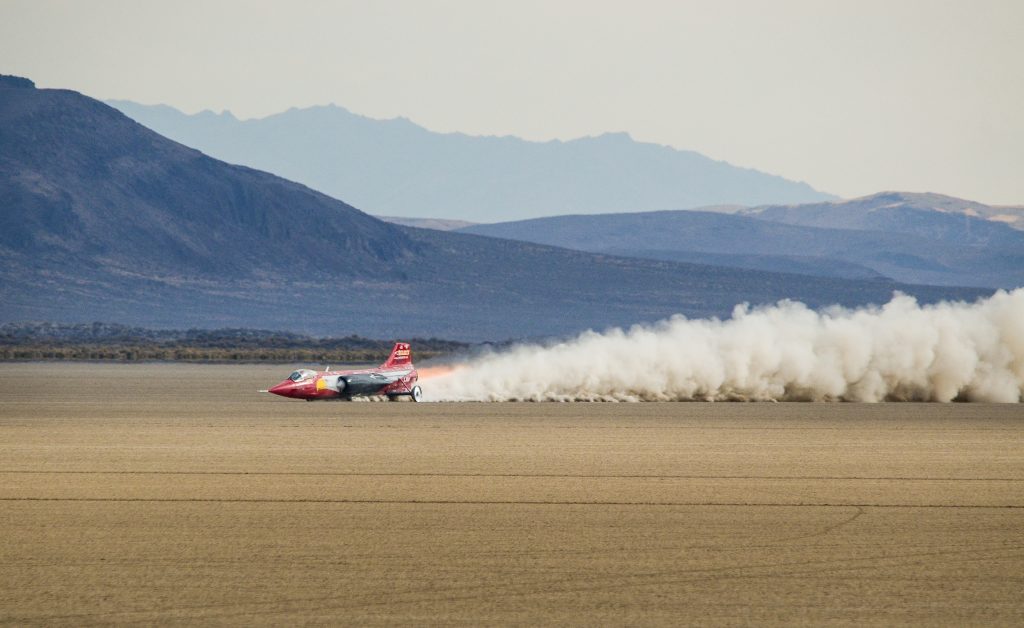 Smoke plume trails the North American Eagle during a speed run in the Alvord Desert