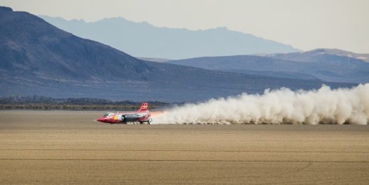 Smoke plume trails the North American Eagle during a speed run in the Alvord Desert