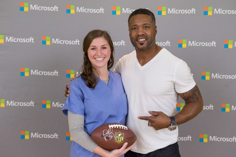 New England Patriot Legend, Lawyer Milloy with a fan at the Microsoft Store at Prudential Center (Boston) on Feb. 3.