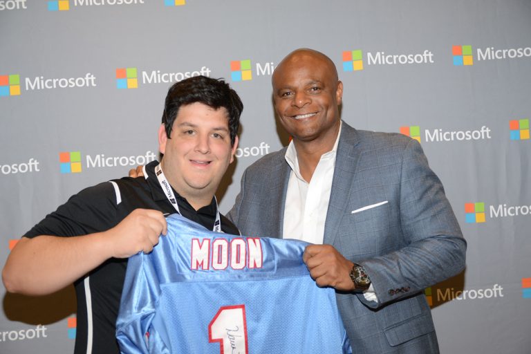Hall of Fame quarterback Warren Moon with a fan at the Microsoft Store at Mall of Millenia (Orlando) during a Pro Bowl celebration event.
