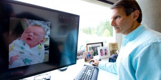 John Kahan looks at a photo of his son, Aaron, on a computer screen