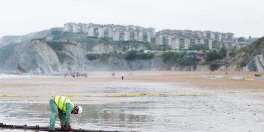 A worker on a beach places the Marea subsea cable
