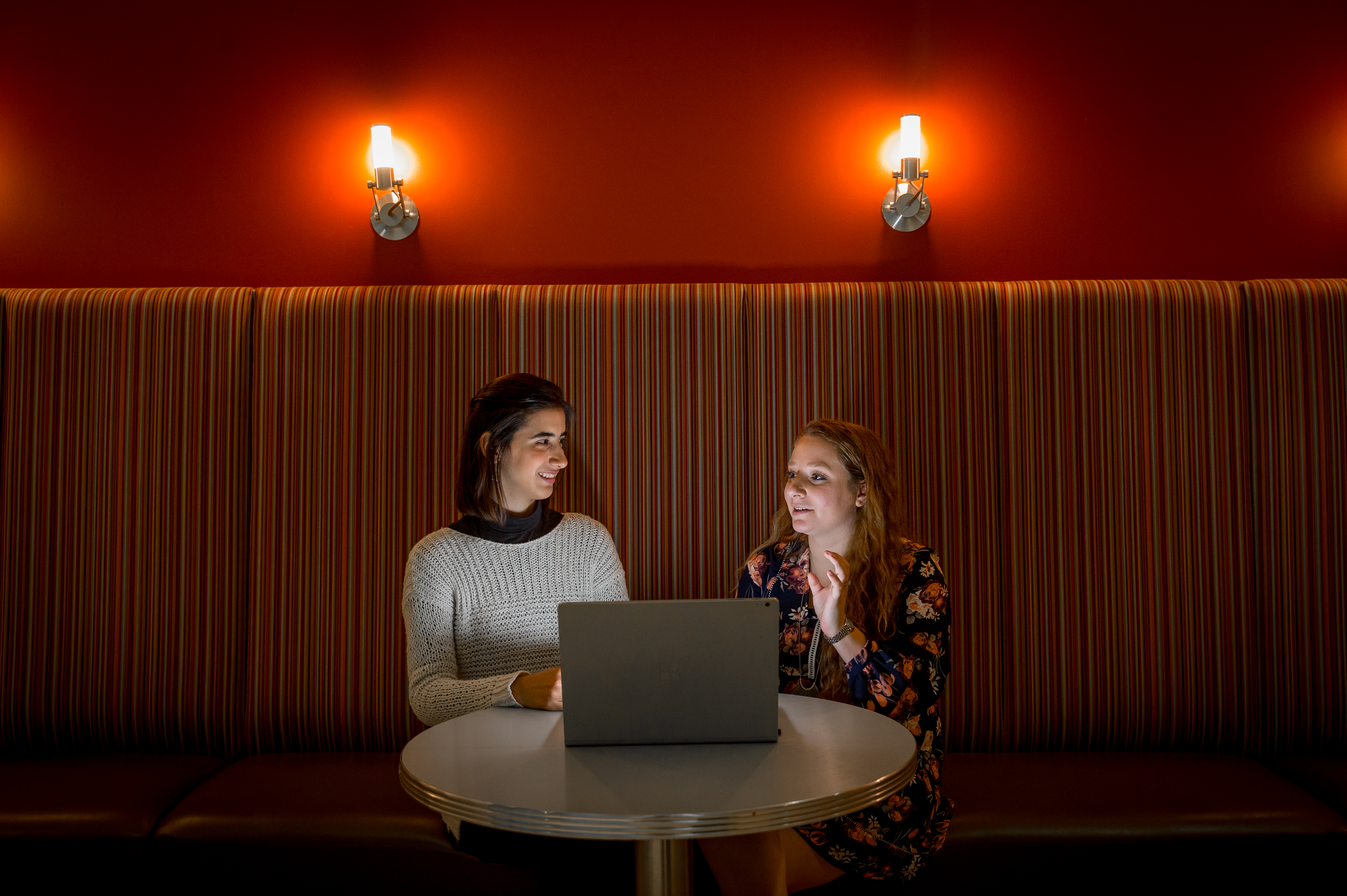 Edaena Salinos Jasso and Heather Shapiro talk around a laptop