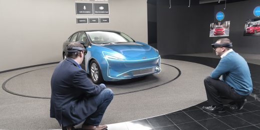 Two men wearing Microsoft HoloLens looking at a hologram of a Ford vehicle