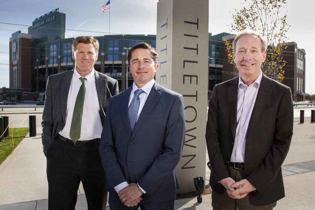 Mark Murphy, president & CEO, Green Bay Packers; Ed Policy, vice president & general counsel, Green Bay Packers; and Brad Smith, president, Microsoft, [pictured left-to-right] in Green Bay’s Titletown District, adjacent Lambeau Field, to announce TitletownTech. 